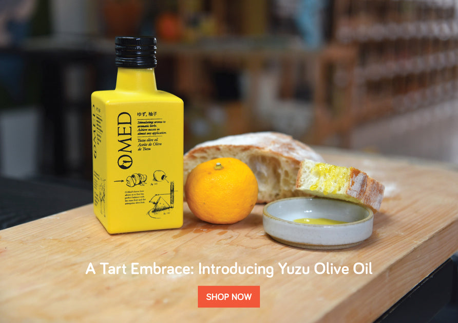 Omed Olive OIl bottles alongside yuzu and rustic bread.