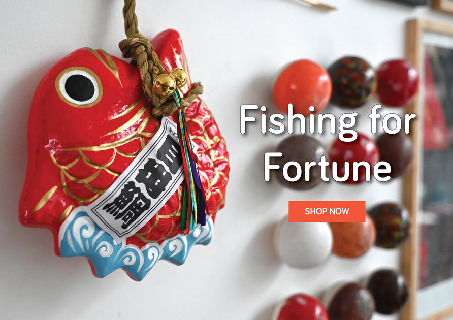Medetai Hariko paper mache objets on the wall. Fishing for Fortune. Shop now.
