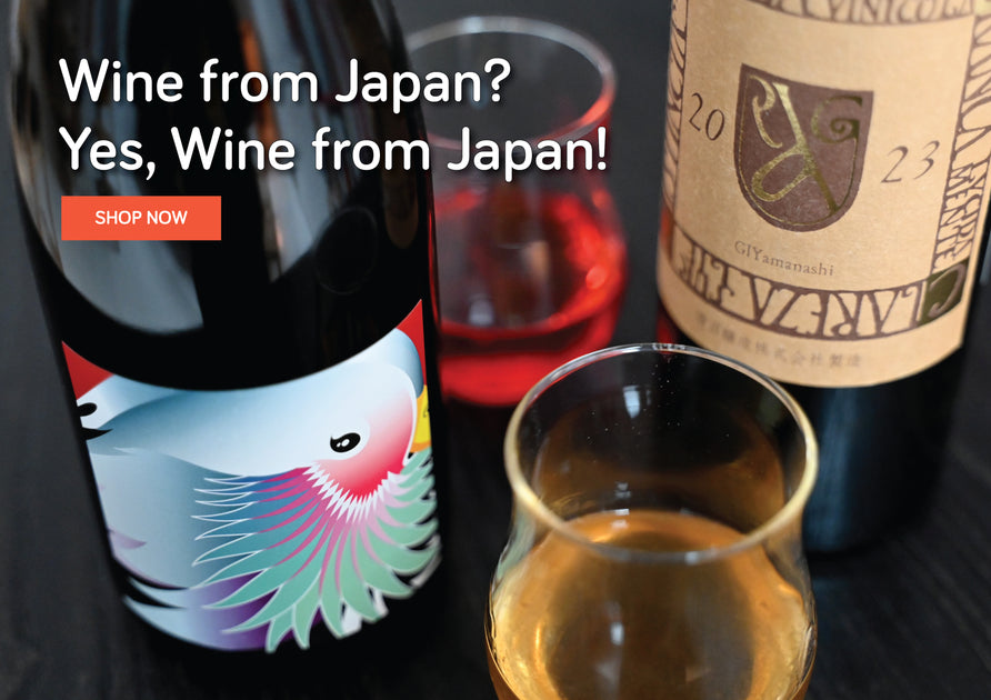 Wine from Japan? Yes, Wine from Japan. Two wines on a bar top with wines in glasses.