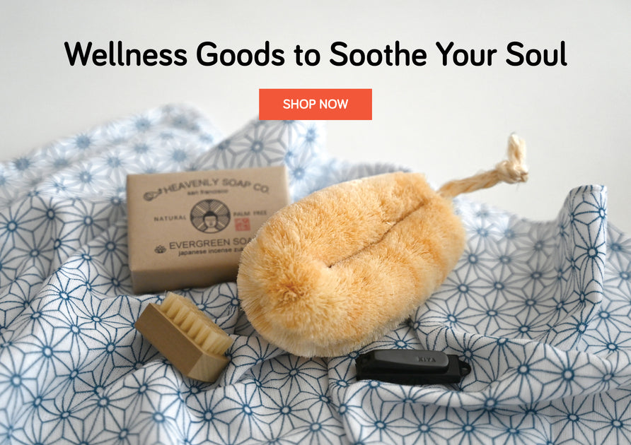 Body scrub tawashi, evergreen soap, nail brush and nail clipper on a soft cloth.