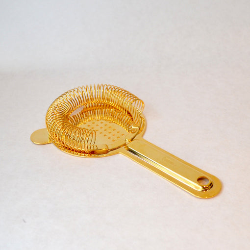 gold hawthorne strainer long This traditional Hawthorne-style strainer is distinctive with its long handle and heavy weight. Shake or stir your cocktail, and the tight coil helps to better strain out ice and any other ingredients as you pour the drink into a glass.